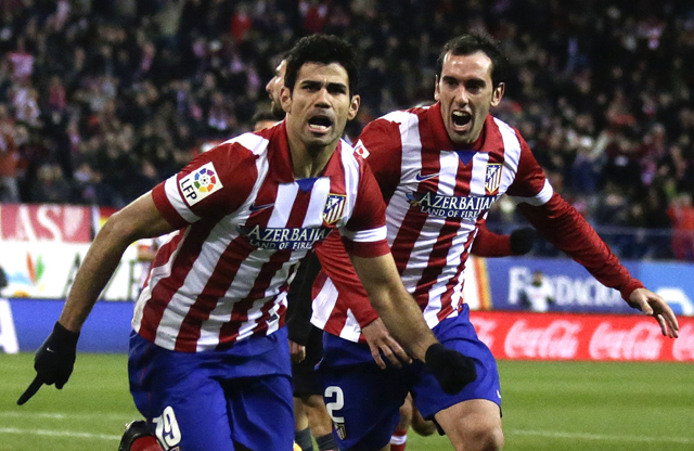 Atletico Madrid's Diego Costa celebrates his goal against Levante with teammate Diego Godin during their Spanish first division soccer match in Madrid