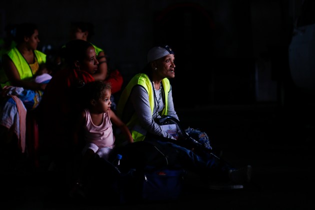 Evicted residents of Tower of David wait for a bus to transport them to their new homes in Caracas