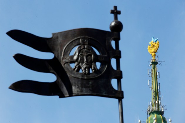 A Soviet-style star re-touched with blue paint so it resembles the yellow-and-blue national colours of Ukraine, is seen atop the spire of a building in Moscow