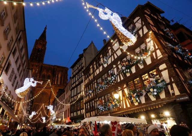 Tourists visit the traditional Christkindelsmaerik (Christ Child market) near Strasbourg's Cathedral