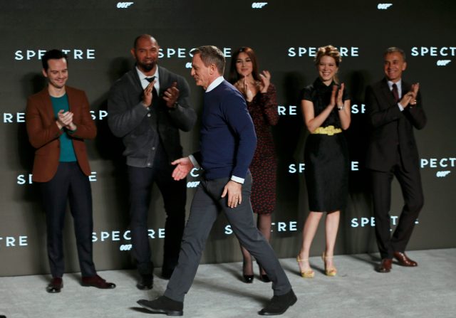Cast members applaud as actor Daniel Craig joins them on stage during an event to mark the start of production for the new James Bond film "Spectre" at Pinewood Studios