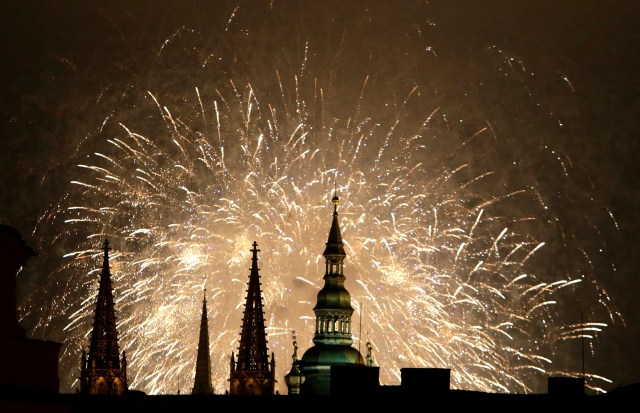 Fireworks explode over the towers of the St. Vitus Cathedral at Prague Castle to mark the first day of the new year in Prague