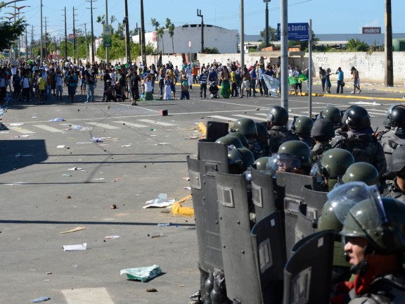 Demonstrators face off against riot police near the Estadio Castelao in Fortaleza