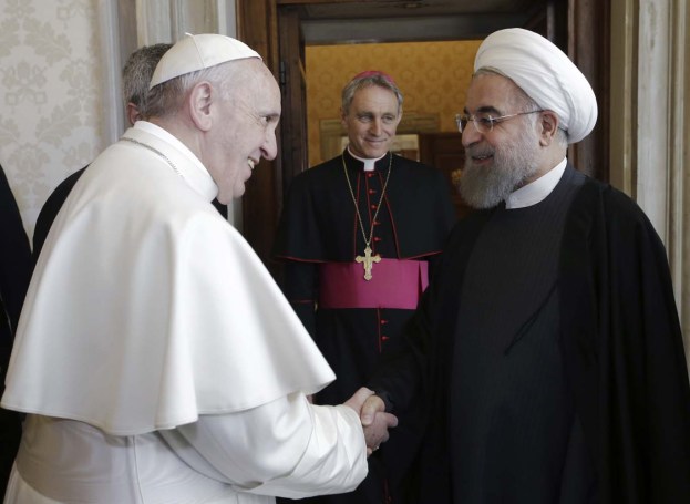 Iran's President Hassan Rouhani (R) is welcomed by Pope Francis at the Vatican January 26, 2016.  REUTERS/Andrew Medichini/Pool      TPX IMAGES OF THE DAY