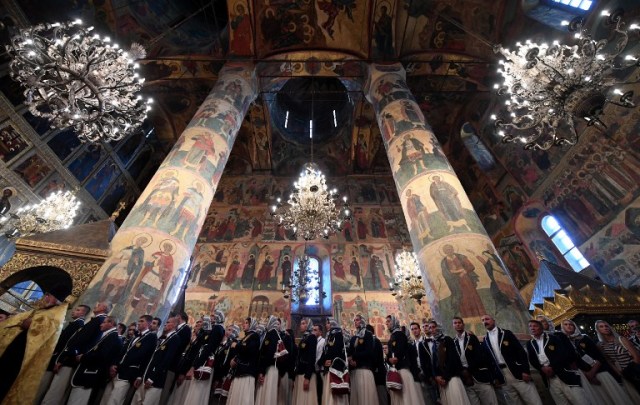Members of Russia's Olympic team wait to receive blessings from Russian Orthodox Patriarch Kirill during a religious service at a cathedral in the Kremlin in Moscow on July 27, 2016. President Vladimir Putin said Wednesday the absence of top Russian competitors will "markedly lower" next month's Rio Games, as he met competitors set for Brazil and those barred over state-run doping. / AFP PHOTO / Kirill KUDRYAVTSEV
