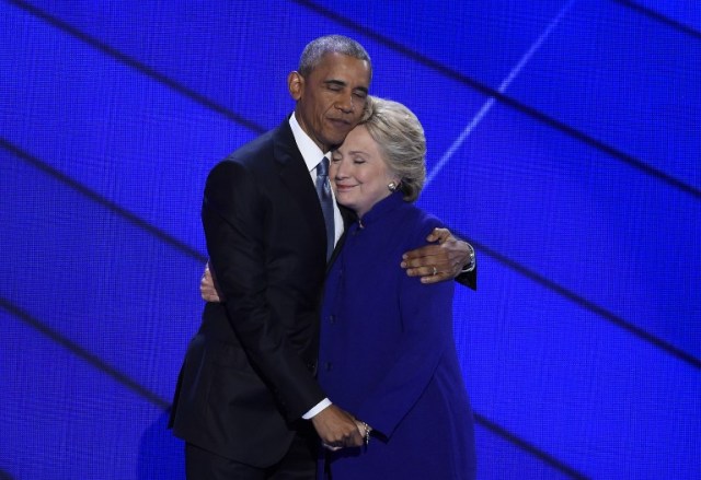 US President Barack Obama and Democratic presidential nominee Hillary Clinton embrace on stage during Day 3 of the Democratic National Convention at the Wells Fargo Center, July 27, 2016 in Philadelphia, Pennsylvania. / AFP PHOTO / SAUL LOEB