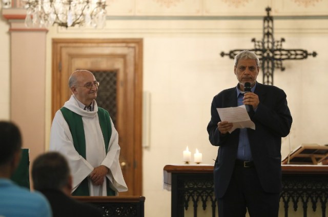 Bagnolet's Mosque's rector Mohamed Rakkaby (R) flanked by Bagnolet's priest Patrick Morvan (L) pronounces a speech to Christian and Muslim believers during a Mass in tribute to priest Jacques Hamel at the Saint-Leu ? Saint-Gilles Bagnolet's Church, near Paris, on July 31, 2016. Muslims across France were invited to participate in Catholic ceremonies today to mourn a priest whose murder by jihadist teenagers sparked fears of religious tension. Masses will be celebrated across the country in honour of octogenarian Father Jacques Hamel, whose throat was cut in his church on July 26, 2016 in the latest jihadist attack on France. / AFP PHOTO / Thomas SAMSON