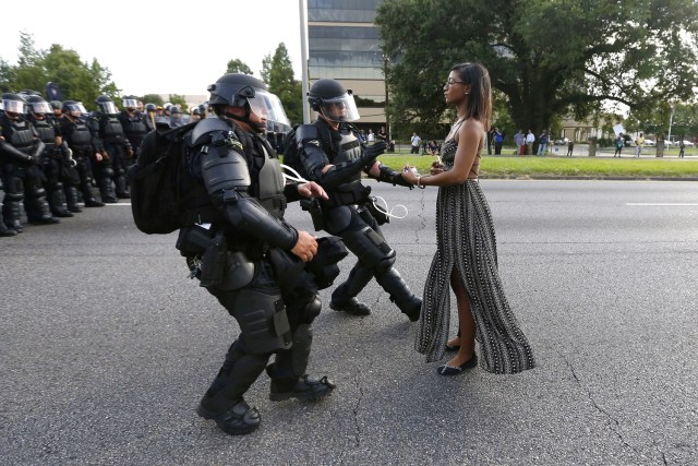 FILE PHOTO - A demonstrator protesting the shooting death of Alton Sterling is detained by law enforcement near the headquarters of the Baton Rouge Police Department in Baton Rouge, Louisiana, U.S. July 9, 2016. REUTERS/Jonathan Bachman/File Photo REUTERS PICTURES OF THE YEAR 2016 - SEARCH 'POY 2016' TO FIND ALL IMAGES