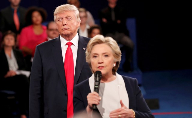FILE PHOTO - Republican U.S. presidential nominee Donald Trump listens as Democratic nominee Hillary Clinton answers a question from the audience during their presidential town hall debate at Washington University in St. Louis, Missouri, U.S., October 9, 2016. REUTERS/Rick Wilking/File Photo REUTERS PICTURES OF THE YEAR 2016 - SEARCH 'POY 2016' TO FIND ALL IMAGES