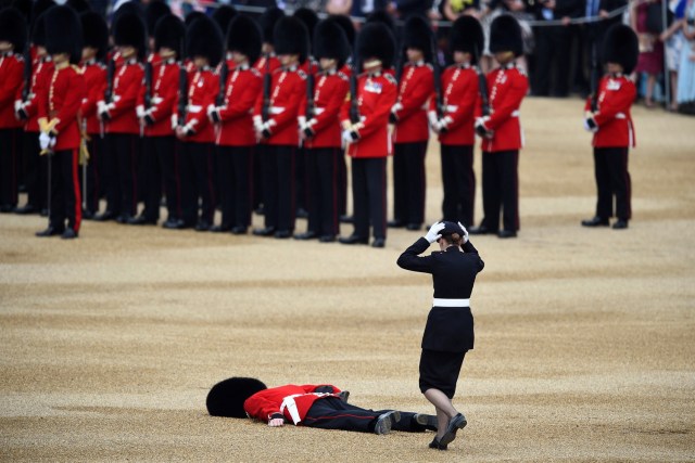 FILE PHOTO - A Guardsman faints at Horseguards Parade for the annual Trooping the Colour ceremony in central London, Britain June 11, 2016. Trooping the Colour is a ceremony to honour Queen Elizabeth's official birthday. REUTERS/Dylan Martinez/File Photo REUTERS PICTURES OF THE YEAR 2016 - SEARCH 'POY 2016' TO FIND ALL IMAGES