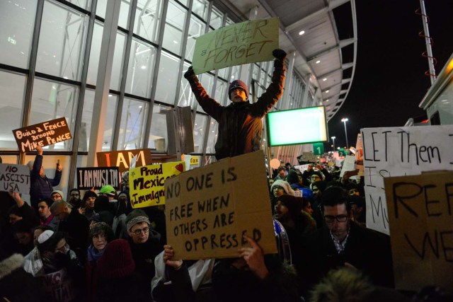 NEW YORK, NY - JANUARY 28: Protestors rally during a demonstration against the new immigration ban issued by President Donald Trump at John F. Kennedy International Airport on January 28, 2017 in New York City. President Trump signed the controversial executive order that halted refugees and residents from predominantly Muslim countries from entering the United States. Stephanie Keith/Getty Images/AFP