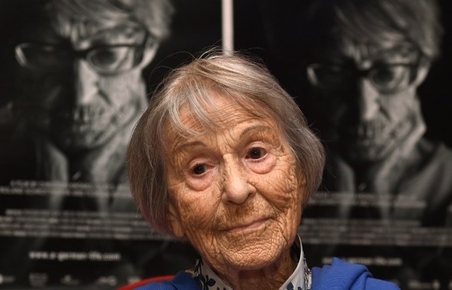(FILES) This file photo taken on June 29, 2016 shows Brunhilde Pomsel, former secretary of Nazi propaganda chief Joseph Goebbels, sitting on a cinema chair in front of posters for the movie "A German Life" in a cinema in Munich, southern Germany. Brunhilde Pomsel died on January 27, 2017 at the age of 106, it was announced on January 30, 2017. / AFP PHOTO / CHRISTOF STACHE