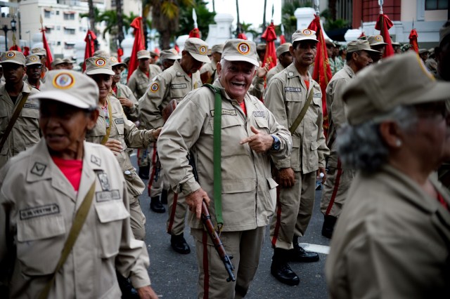 Members of the Bolivarian Militia take part in a parade in the framework of the seventh anniversary of the force, in front of the Miraflores presidential palace in Caracas on April 17, 2017. Venezuela's defence minister on Monday declared the army's loyalty to Maduro, who ordered troops into the streets ahead of a major protest by opponents trying to oust him. Venezuela is bracing for what Maduro's opponents vow will be the "mother of all protests" Wednesday, after two weeks of violent demos against moves by the leftist leader and his allies to tighten their grip on power.  / AFP PHOTO / Federico PARRA