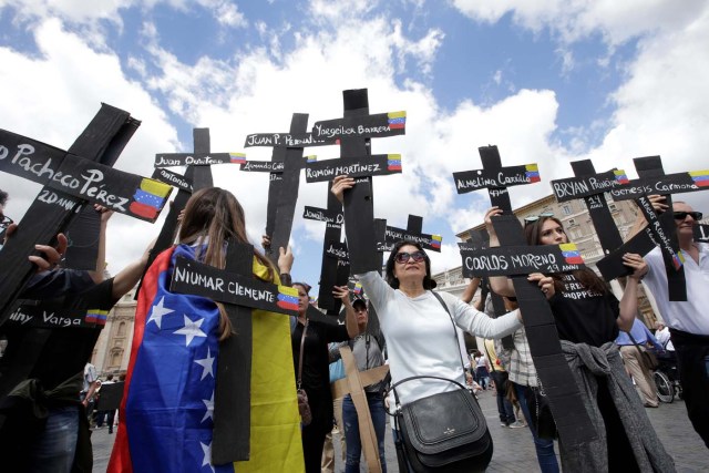 The faithful from Venezuela hold crosses with names of people who died during protests in Venezuela, before the Regina Coeli prayer led by Pope Francis in Saint Peter's Square at the Vatican May 7, 2017. REUTERSMax Rossi