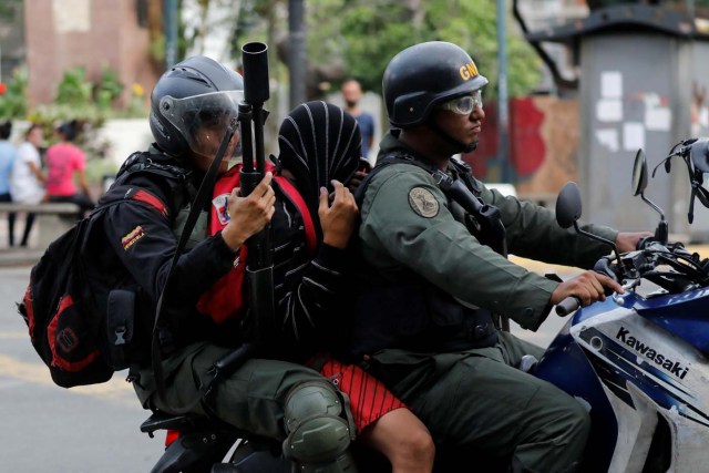 A demonstrator is detained by riot security forces during a protest against Venezuela's President Nicolas Maduro's government in Caracas, Venezuela June 14, 2017. REUTERS/Carlos Garcia Rawlins