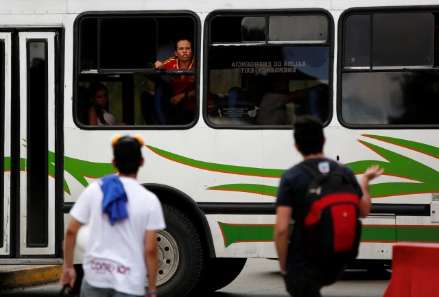 A female passenger on a bus argues with opposition supporters blocking a street during a rally against Venezuela's President Nicolas Maduro's Government in Caracas, Venezuela, June 30, 2017. REUTERS/Ivan Alvarado