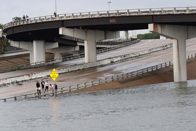 People view the flooded highways in Houston on August 27, 2017 as the city battles with tropical storm Harvey and resulting floods. Massive flooding unleashed by deadly monster storm Harvey left Houston -- the fourth-largest city in the United States -- increasingly isolated Sunday as its airports and highways shut down and residents fled homes waist-deep in water. / AFP PHOTO / Thomas B. Shea