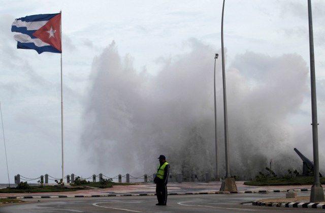 FILE PHOTO: A police officer stands on the seafront boulevard El Malecon ahead of the passing of Hurricane Irma, in Havana, Cuba September 9, 2017. REUTERS/Stringer NO SALES. NO ARCHIVES/File Photo