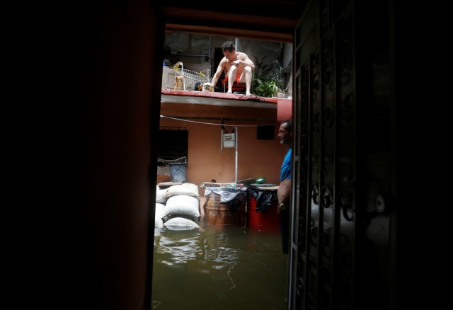 A man stands in the flooded passage of a block of flats after the passing of Hurricane Irma in Havana, Cuba, September 10, 2017. REUTERS/Stringer NO SALES. NO ARCHIVES