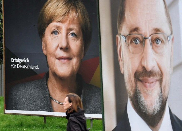 Election posters of German Chancellor Angela Merkel of the Christian Democratic Party CDU and Social Democratic Party SPD leader and top candidate Martin Schulz are seen in Hamburg, Germany, September 24, 2017. REUTERS/Fabian Bimmer