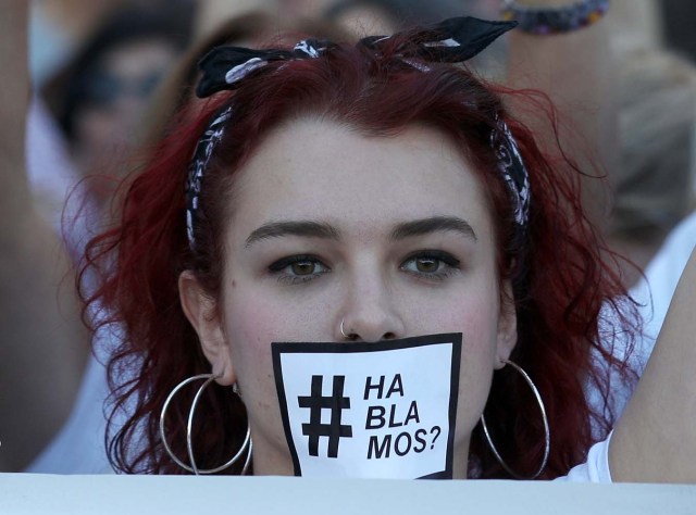 A woman wears a sticker over her mouth which reads "Shall we talk?" in Spanish during a demonstration in favour of dialogue to resolve Catalonia´s bid for independence, in Madrid, Spain, October 7, 2017. REUTERS/Sergio Perez