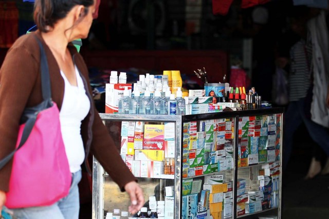 A woman walks past a stall selling medicines at Las Pulgas market in Maracaibo, Venezuela December 5, 2017. Picture taken December 5, 2017. REUTERS/Isaac Urrutia