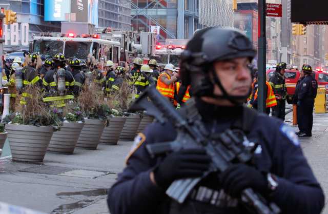 Police officers and fire crew stand outside the New York Port Authority Bus Terminal in New York City, U.S. December 11, 2017 after reports of an explosion. REUTERS/Lucas Jackson