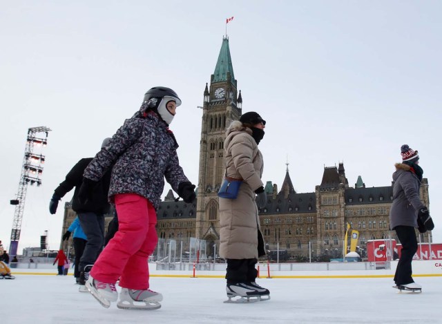 People brave the frigid weather to skate on an outdoor rink on Parliament Hill in Ottawa, Ontario, Canada, December 29, 2017. REUTERS/Patrick Doyle