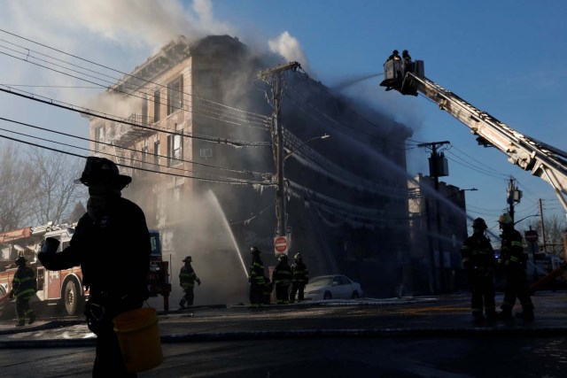Fire Department of New York (FDNY) firemen work at an apartment building in the Bronx, New York, U.S. January 2, 2018. REUTERS/Shannon Stapleton