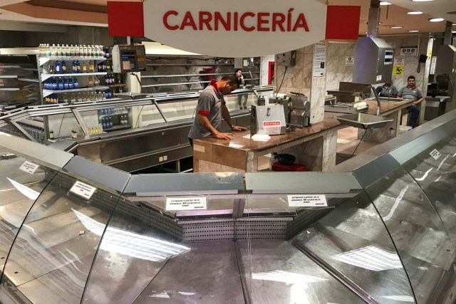 Empty refrigerators are seen at the butchery area in a supermarket in Caracas, Venezuela January 9, 2018. REUTERS/Marco Bello