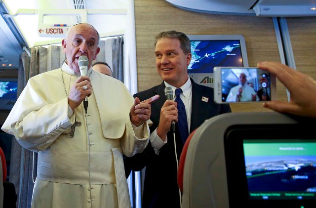 Pope Francis speaks to reporters onboard the plane for his trip to Chile and Peru January 15, 2018. REUTERS/Alessandro Bianchi
