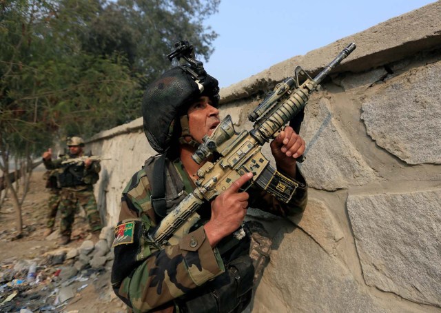 A member of Afghan security forces takes position at the site of a blast and gun fire in Jalalabad, Afghanistan January 24, 2018.REUTERS/Parwiz