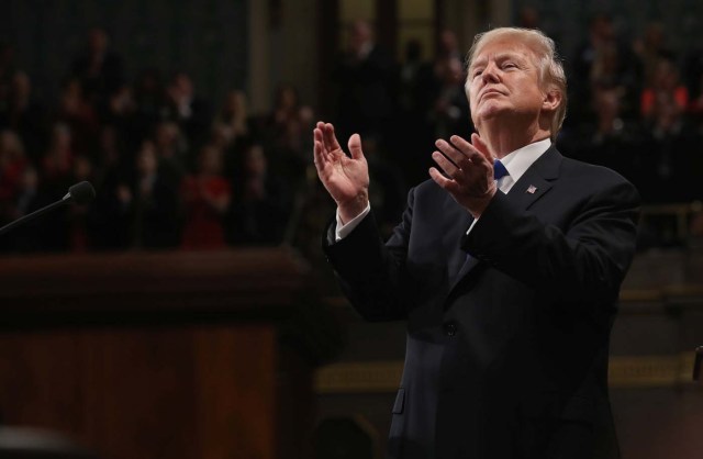 U.S. President Donald Trump applauds during his first State of the Union address to a joint session of Congress inside the House Chamber on Capitol Hill in Washington, U.S., January 30, 2018. REUTERS/Win McNamee/Pool TPX IMAGES OF THE DAY