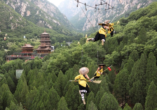 Shaolin martial arts students perform Kung Fu suspended on wires in a rehearsal for a live-action night show in Zhengzhou, Henan province, China April 28, 2018. Picture taken April 28, 2018. REUTERS/Stringer ATTENTION EDITORS - THIS IMAGE WAS PROVIDED BY A THIRD PARTY. CHINA OUT. NO COMMERCIAL OR EDITORIAL SALES IN CHINA.